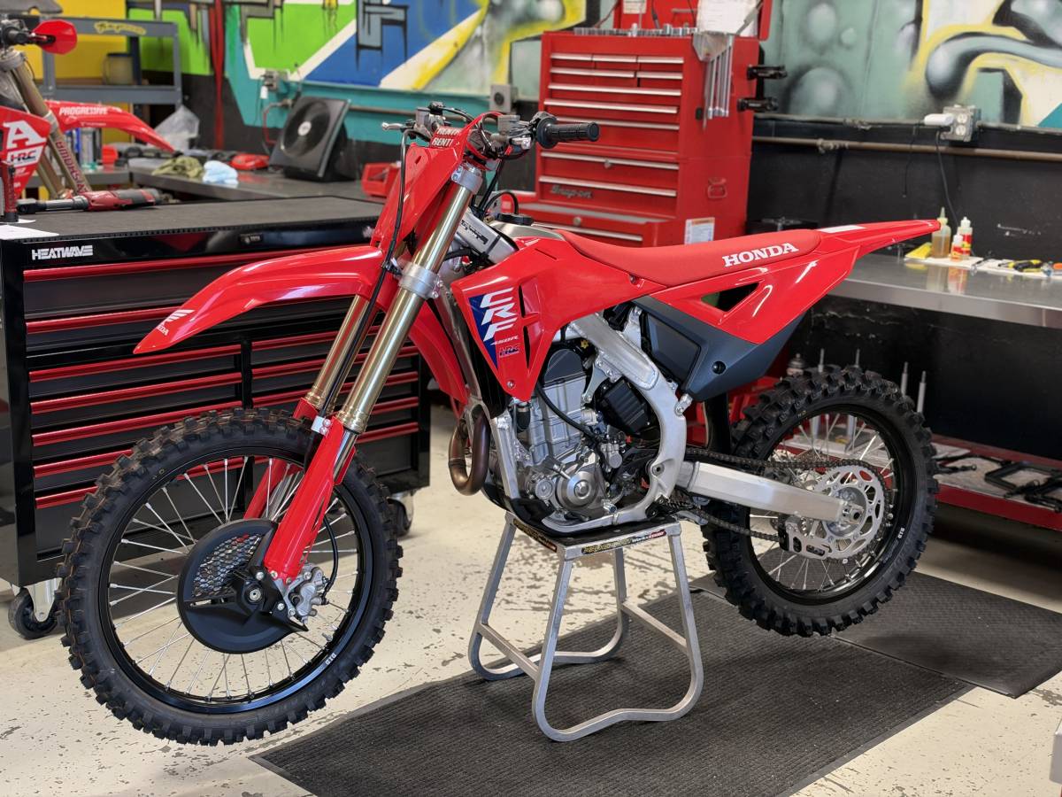 Stock 2026 Honda CRF450R on a stand in the workshop before race prep and chassis service